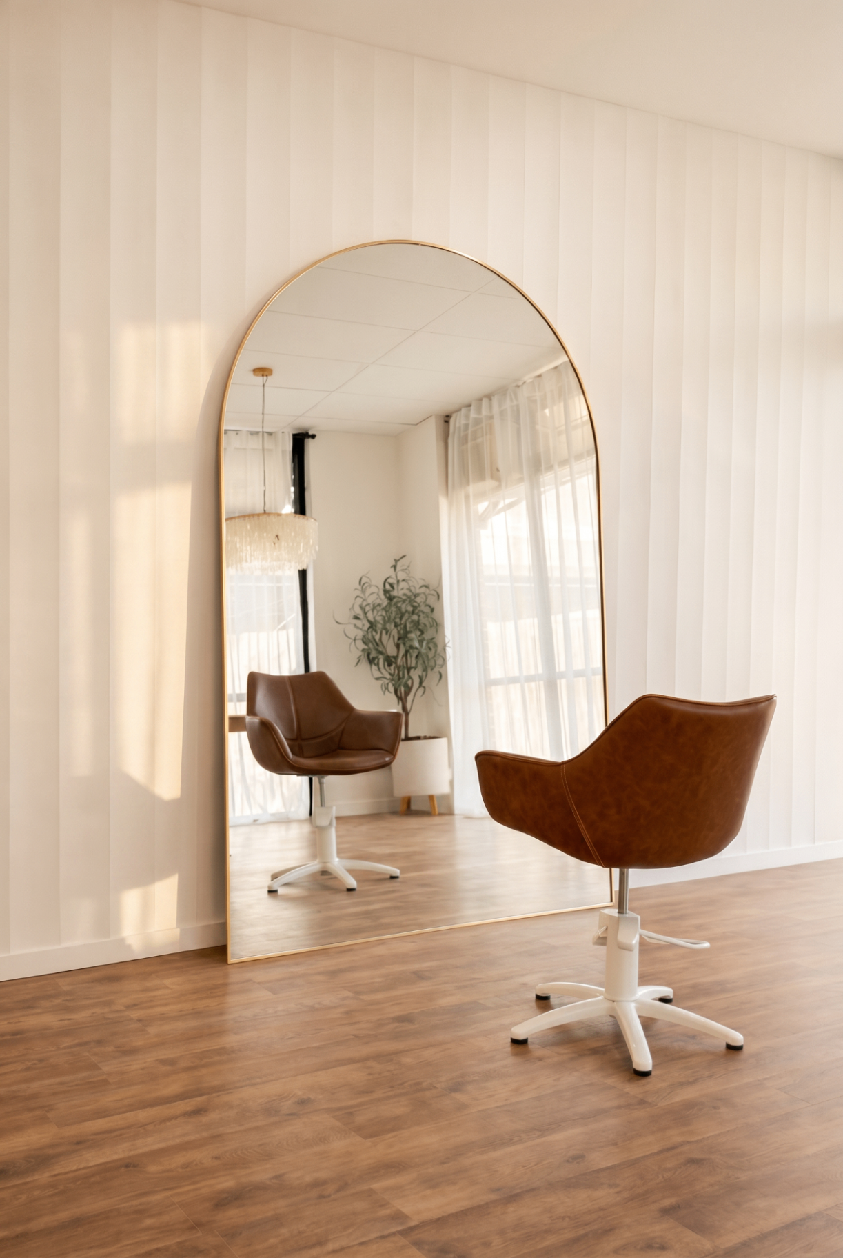 Styling chair beside arched full-length mirror